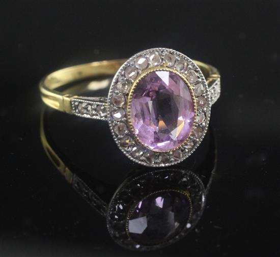 A gold, pink topaz and diamond oval cluster ring, size P.